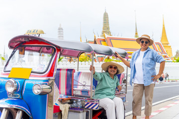 Happy Asian senior woman tourist travel Bangkok city, Thailand on summer holiday vacation. Elderly...