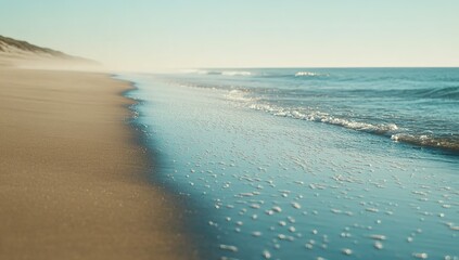 Obraz premium Tranquil Beach Scene With Golden Sand And Blue Waves