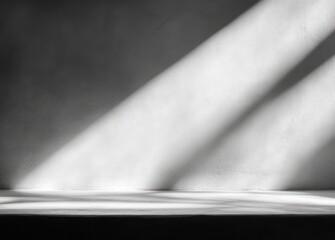 Fototapeta premium Dark empty room with smooth textured wall and floor lit by diagonal shafts of light creating a calm and minimalist atmosphere