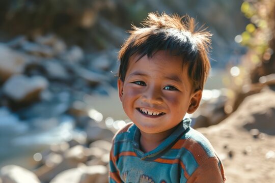 Portrait of a smiling little boy in a blue shirt against the background of the river - Powered by Adobe