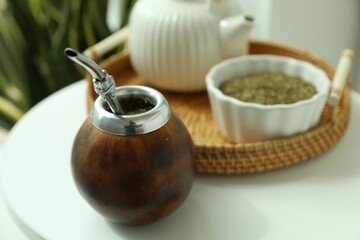 Traditional yerba mate tea on white table indoors, closeup