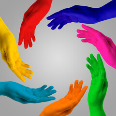 Making circle of human hands painted in different colors on grey background. Unity, partnership, cooperation