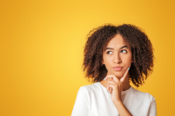 Difficult choice, proposal or decision. Pensive young african american woman with curly hair in...