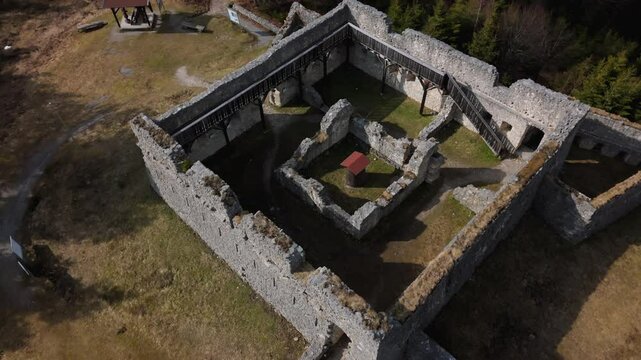 Drone footage of Fort Claudia in Tyrol, Austria, part of Ehrenberg fortification system. This high-angle view reveals ancient stone walls, mountain defense structures and Austrian Alps scenery. 