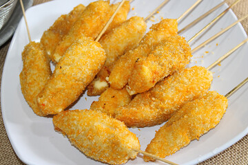 Fried nuggets on skewers. a plate of satay nugget dishes
