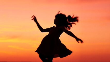 Dancing Silhouette Against Fiery Sunset
