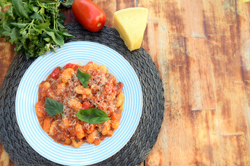 Gnocchi with red Bolognese sauce, typical Italian pasta potato food taste