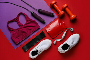 Composition with healthy snack, sports equipment and shoes on color background