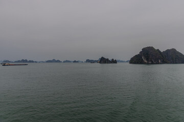 Halong Ha Long Bay Hanoi this Vietnamese wonder is littered with mountains and Rock cliffs popping out of the ocean, lush green mountains in Vietnam