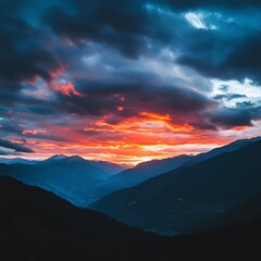 Fototapeta premium Breathtaking sunset over mountains with dramatic clouds and vibrant colors.