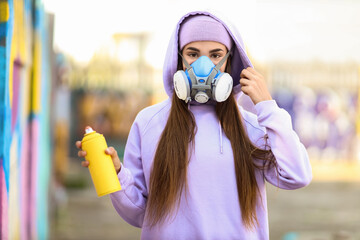 Teenage girl with spray paint outdoors