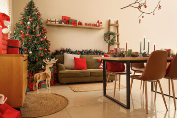 Interior of dining room with table, sofa and Christmas tree