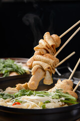 Lift the skewered fish cake
