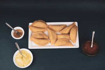 Colombian empanada with spicy sauce 