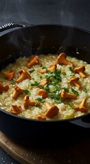 Creamy risotto with wild-foraged chanterelles, vegetable scrap broth, and Parmesan (or nutritional yeast). Garnished with wild garlic, cast iron pot