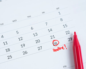 Deadline write on white calendar page date close up