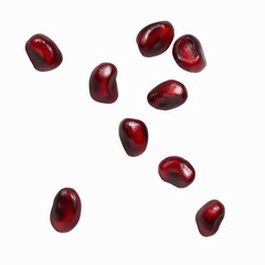 Falling Pomegranate Seeds on a Dark Transparent background