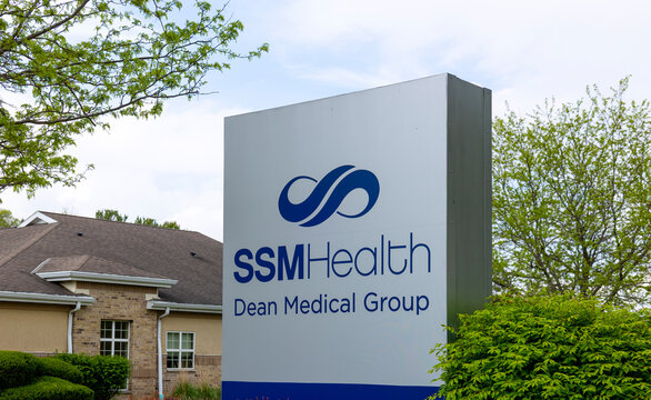 A SSM Health Dean Medical Group sign with a clinic in the background. 