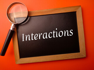 Wooden board with the word Interactions on a orange background