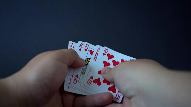 Close-up video showing the perfect poker hand: a royal straight flush laid out on the table. Ace-high hearts in a clean, dramatic reveal &ndash; the ultimate winning combination.