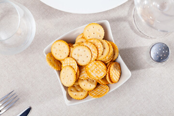 Delicious round crackers in a plate, placed on the table. Close-up image