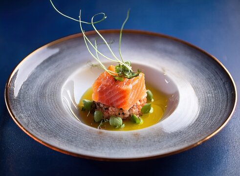Elegant modern plating of rfissa with minimalist garnish, served in a fine dining restaurant ambiance
