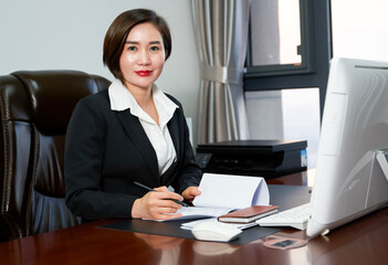 Mature and stable Asian white-collar woman sitting in the office