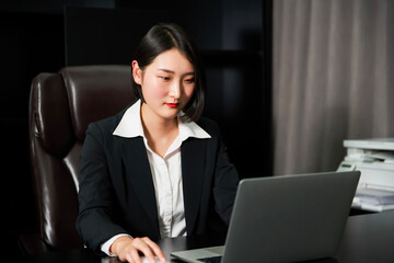 Asian business woman sitting in office