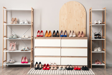 Interior of room with commode, shelf units and women's shoes