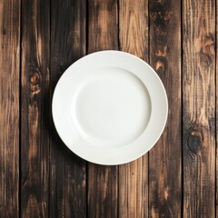Minimalist overhead shot of white dinner plate on rustic dark wood table for food presentation or blank canvas concept