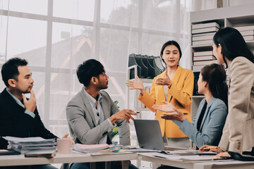 Team of financial advisory services. Asian advisor showing plan of investment to clients in the consultancy office..