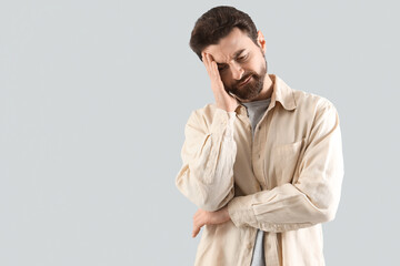 Portrait of worried man on light background