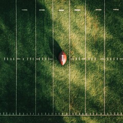 View from above of an American Football sitting on a grass football field on the yard line. Generic Sports image