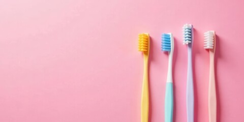 Pastel-Colored Toothbrushes Arranged on a Pink Background, Ideal for Dental Hygiene or Oral Care Product Advertising