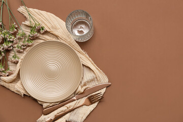 Beautiful table setting with gypsophila flowers on brown background