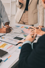 Team of financial advisory services. Asian advisor showing plan of investment to clients in the...