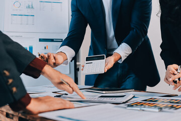 Fototapeta na wymiar Accounting company provide finance and taxation planning for profitable cash flow, Auditor and accountant team working in office, analyze financial data and accounting record with calculator.Insight