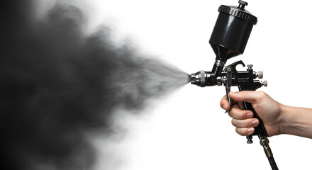 A hand grips a black, cone-shaped spray gun, blasting out a stream of thick, black paint or coating onto a white background