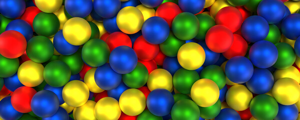 Close-up view of a multitude of brightly colored spheres in red, green, blue, and yellow, forming a vibrant and playful abstract background
