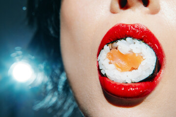 Close-up of a woman's mouth with sushi, featuring red lips and vibrant colors, highlighting the...