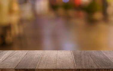 Empty wood table top and blur of restaurant background selective focus product display