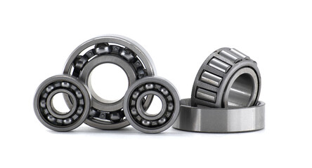 Set of ball bearings and roller bearings lying on white background