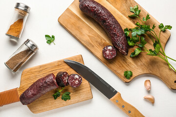 Composition with tasty blood sausage on white background, top view