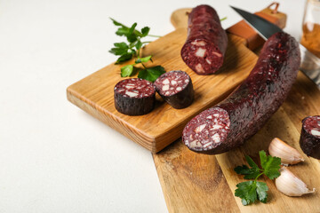 Composition with tasty blood sausage on white background