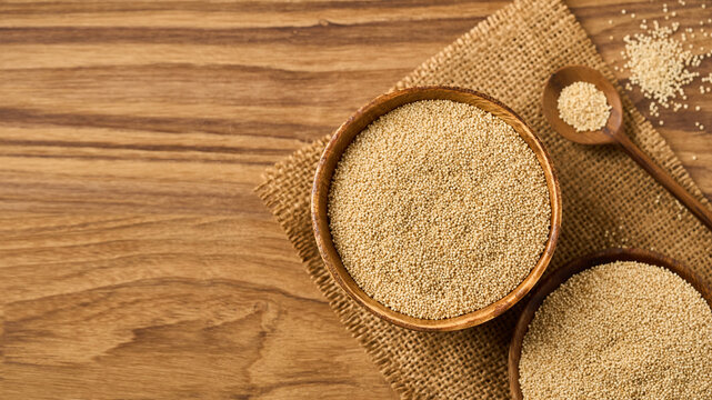 flat lay pile of amaranth seed grain whole in wood bowl on wooden table homemade rustic style food background with copy space