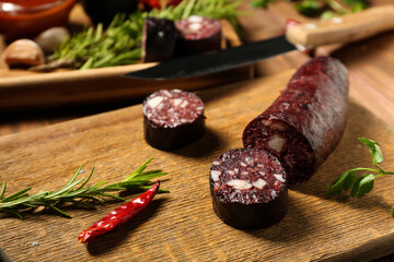 Tasty blood sausage on wooden background, closeup