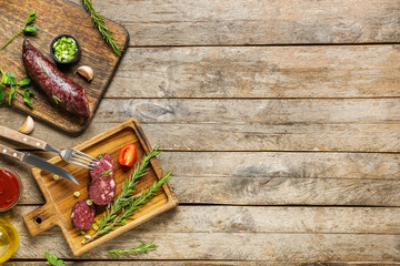 Composition with tasty blood sausage on wooden background, top view