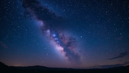 Naklejka premium Vibrant milky way galaxy stretches across the dark night sky with celestial stars afar above earth.