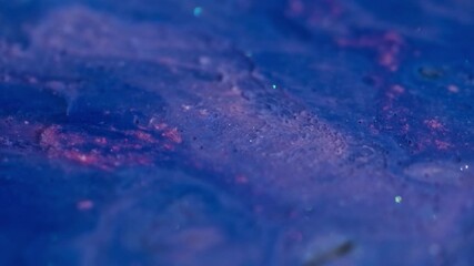 Shiny bubbles. Blend flow. Defocused blue pink colorful oil drop paint in water liquid spreading on abstract art acrylic background.