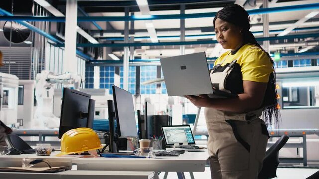 Photovoltaics factory technician designing CAD models and technical sketches for solar modules on laptop. Woman engineer ensures solar panel designs for efficiency and manufacturability. Camera B.